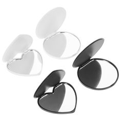 three heart shaped mirrors sitting on top of each other in front of a white background