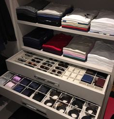 an organized closet with folded shirts, ties and other items in it's drawers