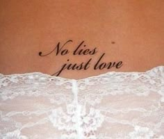 a woman with a tattoo saying no lies just love on her lower back ribcage