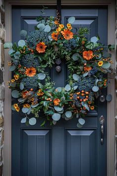 a blue front door with a wreath on it