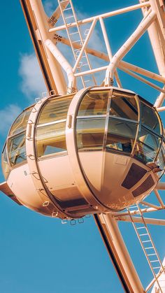 a ferris wheel against a blue sky with clouds