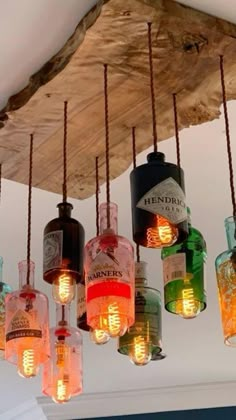 a chandelier made out of bottles hanging from the ceiling