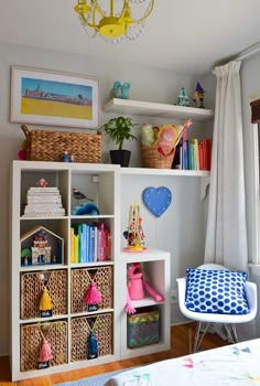 a white shelf filled with lots of books and toys