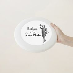 a hand holding a frisbee that says replace with your photo