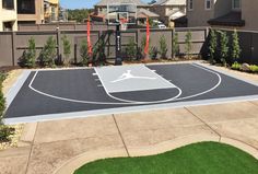 an outdoor basketball court surrounded by houses