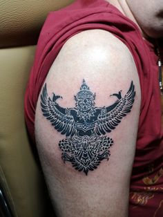 a person with a tattoo on their arm and an eagle in the middle of his arm