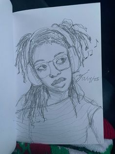 a drawing of a woman with glasses on top of a piece of paper next to a pen