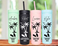 three different colored tumblers with palm trees and names on them, sitting on a table