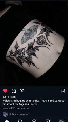 the back of a woman's stomach with flowers and leaves tattooed on her arm