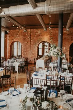 the tables are set for an event with blue and white linens