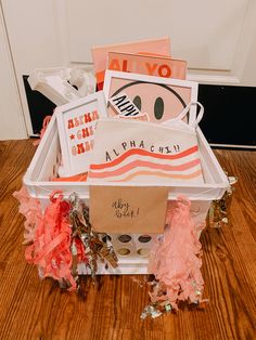 a white basket filled with assorted items on top of a wooden floor