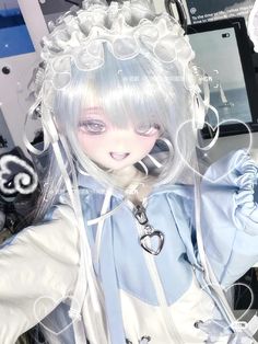 a doll with white hair wearing a blue dress