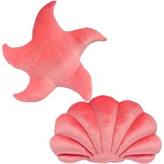 two pink scallop shaped pillows sitting next to each other