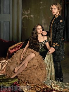 two people dressed in fancy clothing posing for a photo