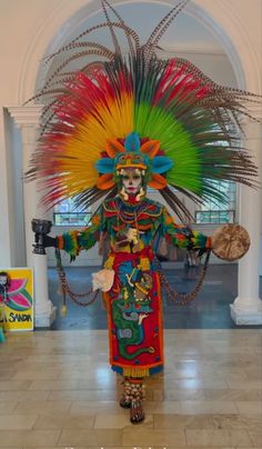 a person dressed in colorful clothing and headdress