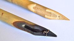 two wooden pencils sitting next to each other on a table