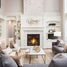 a living room filled with furniture and a fire place in front of a wall mounted map