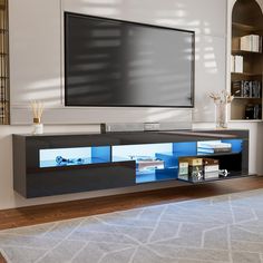 an entertainment center with a flat screen tv mounted on the wall