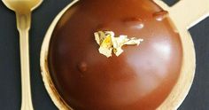 a chocolate dessert on a plate with spoons