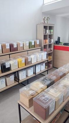 the shelves are filled with different types of food and storage bins on each shelf