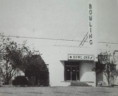 an old photo of a building with a sign on it's side that says bolling