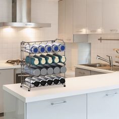 a rack filled with pots and pans sitting on top of a counter in a kitchen