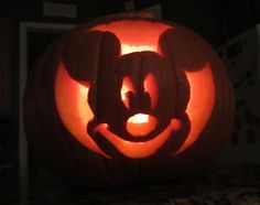 a mickey mouse pumpkin carved into the shape of a face