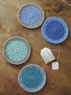 three crocheted plates sitting on top of a wooden table