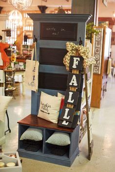 a display in a store filled with lots of pillows and signs on the front of it