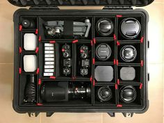 an open camera case filled with cameras and accessories