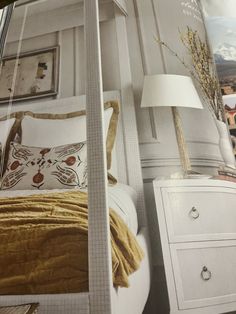 a magazine with an image of a bed and nightstands in it's corner