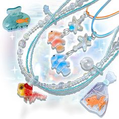 an assortment of necklaces with fish and bubbles attached to the chain, on a white background