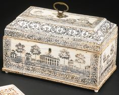 an ornately decorated box next to a playing card