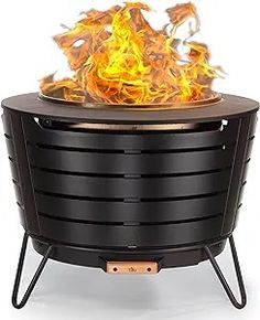 an outdoor fire pit with flames coming out of it's sides and the lid open