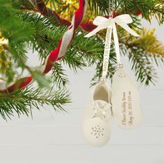 two baby's shoes hanging from a christmas tree