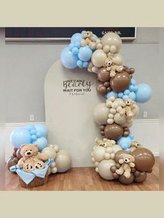 balloons and teddy bears are arranged in the shape of a number one for a baby's first birthday