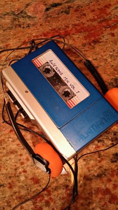 an old tape recorder with two oranges attached to it and wires running through the top