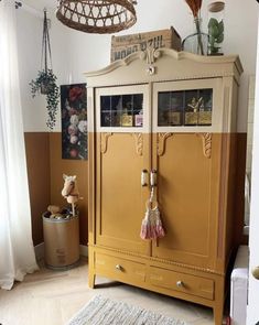 a yellow armoire sitting in the corner of a room