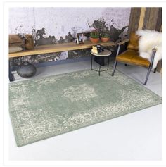 a room with two chairs and a rug on the floor