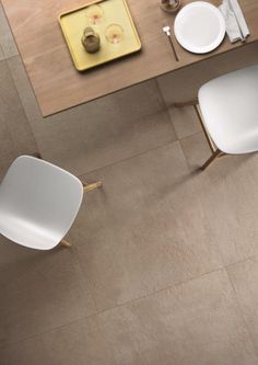 an overhead view of a dining room table with two chairs and plates on the table