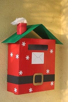 a red mailbox decorated with snowflakes and an envelope in the shape of a santa clause