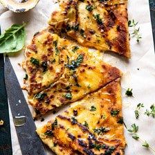 four slices of cheese pizza sitting on top of a cutting board next to a knife