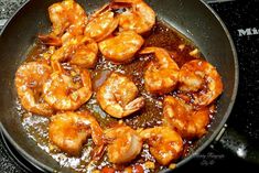 shrimp being cooked in a skillet on the stove