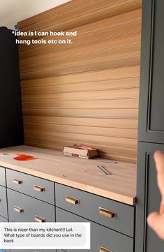 a hand is pointing at a wooden counter top with drawers on it and the caption reads, idea is i can hook and hang tools etc on it