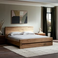 a large bed sitting on top of a wooden floor next to a dresser and window