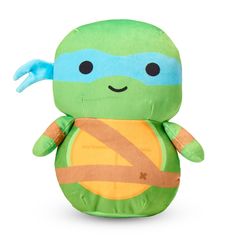 a stuffed turtle toy with a blue mask on it's face and arms, sitting in