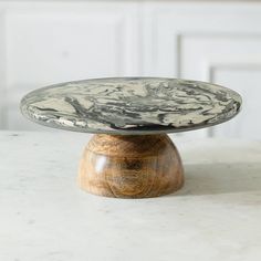 a marble plate sitting on top of a wooden stand