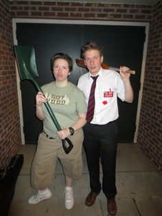 two people standing next to each other in front of a door with an arrow on it