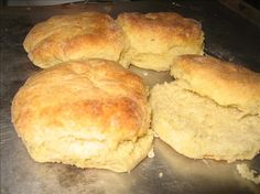 four biscuits sitting on top of a metal pan