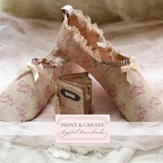 three pairs of shoes that have been made out of fabric and lace, sitting on a bed